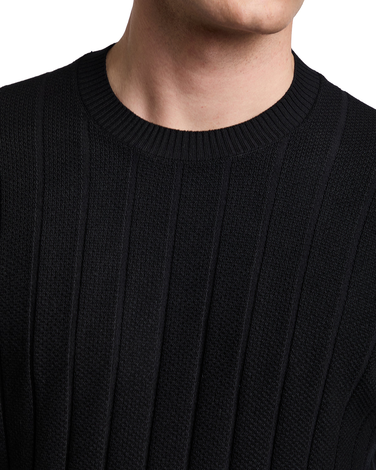 Black ribbed knit sweater with a classic crew neck, perfect for stylish layering in casual or semi-formal outfits.
