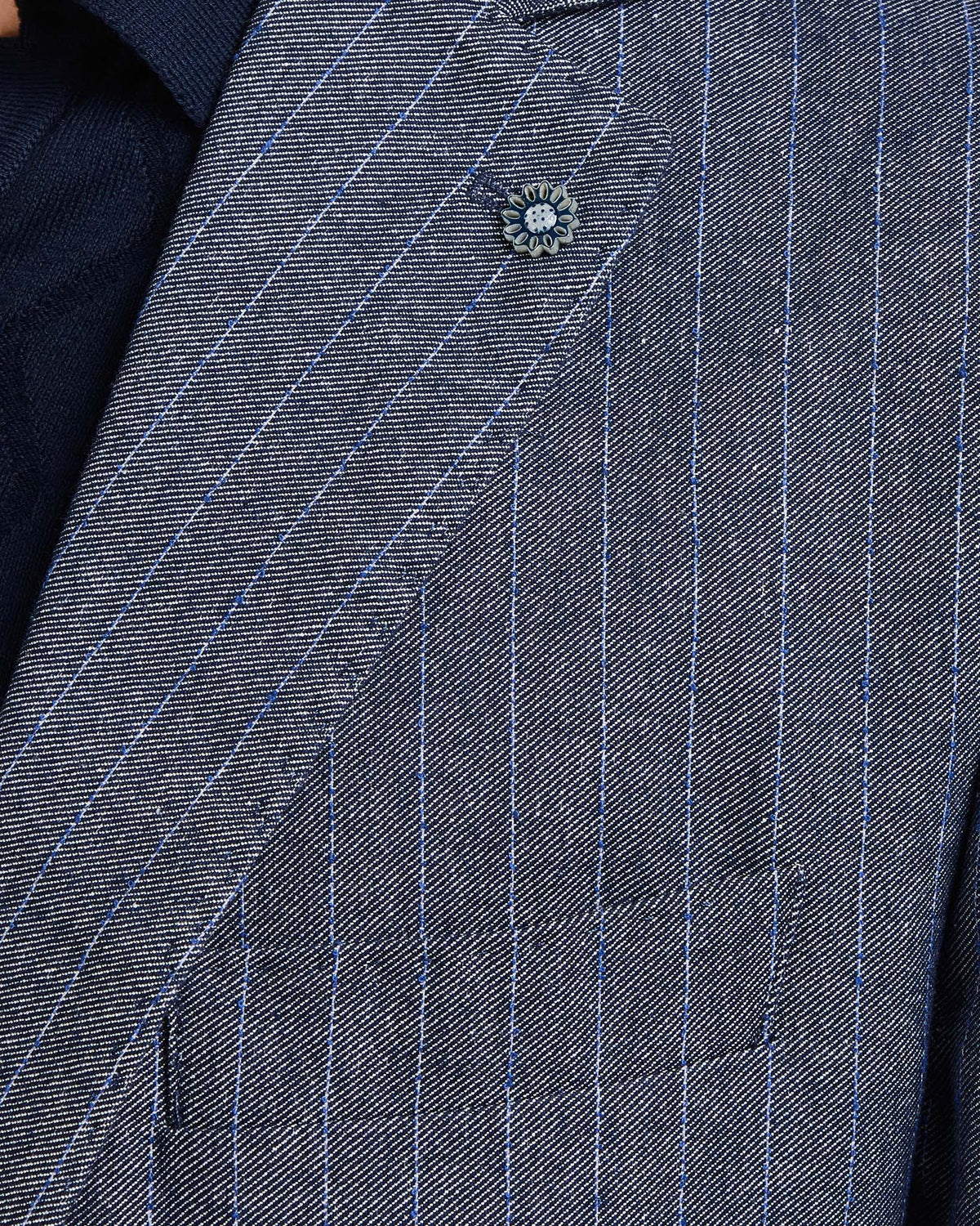 Navy pinstripe suit jacket with contrasting blue lines and floral lapel pin, made from premium fabric.