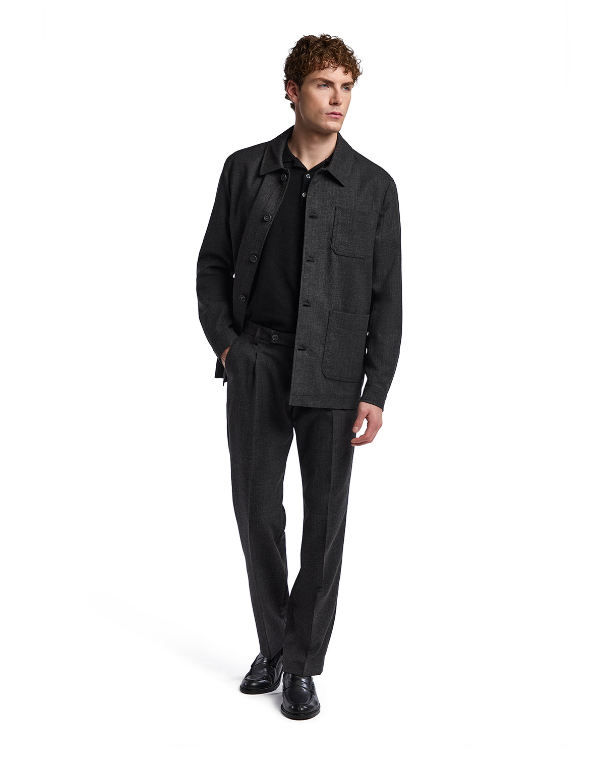 Men's dark grey tailored outfit featuring a button-up jacket and matching trousers in a modern, sleek style.