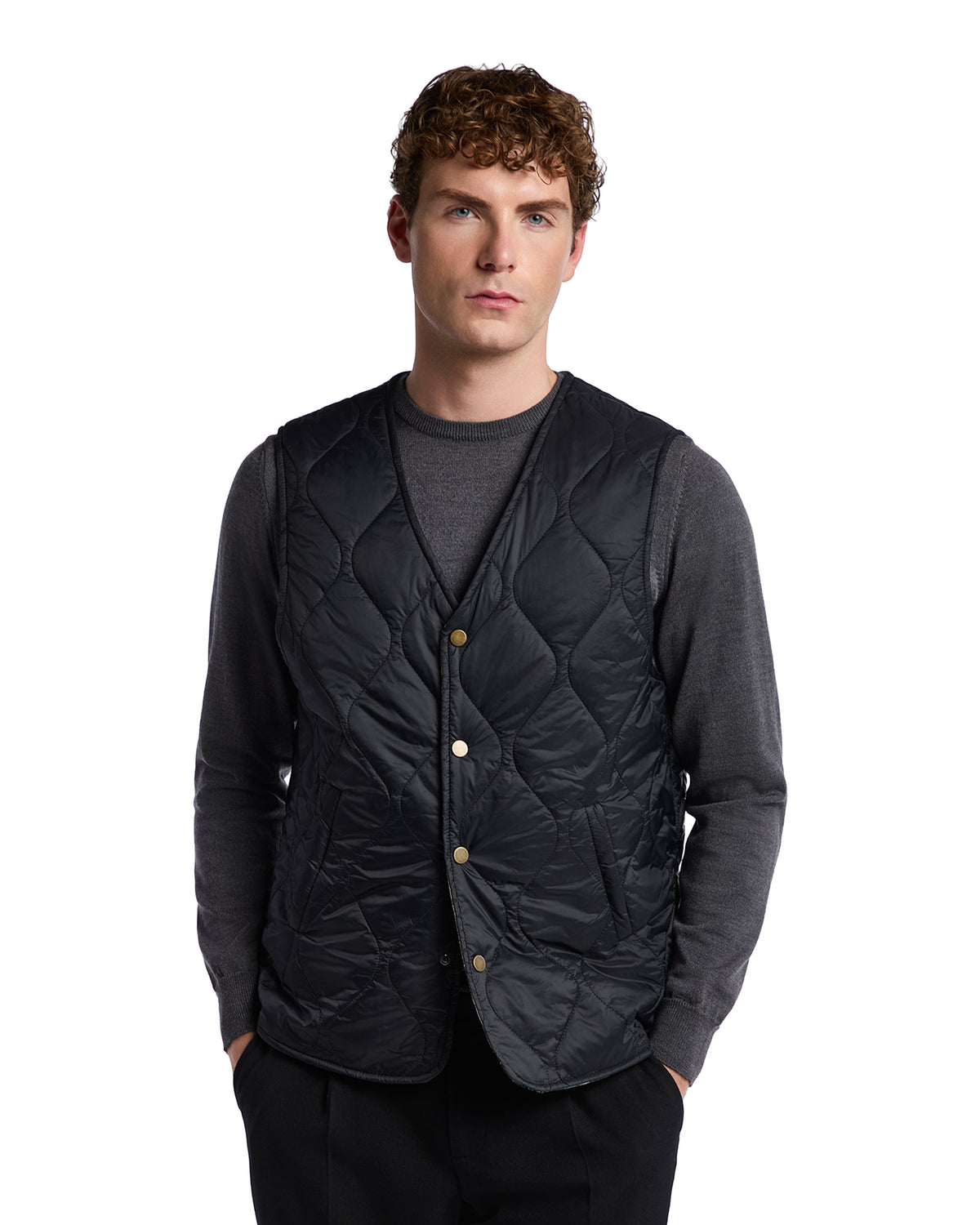 Men's black quilted vest with button closure, made of lightweight nylon, perfect for layering in cool weather.