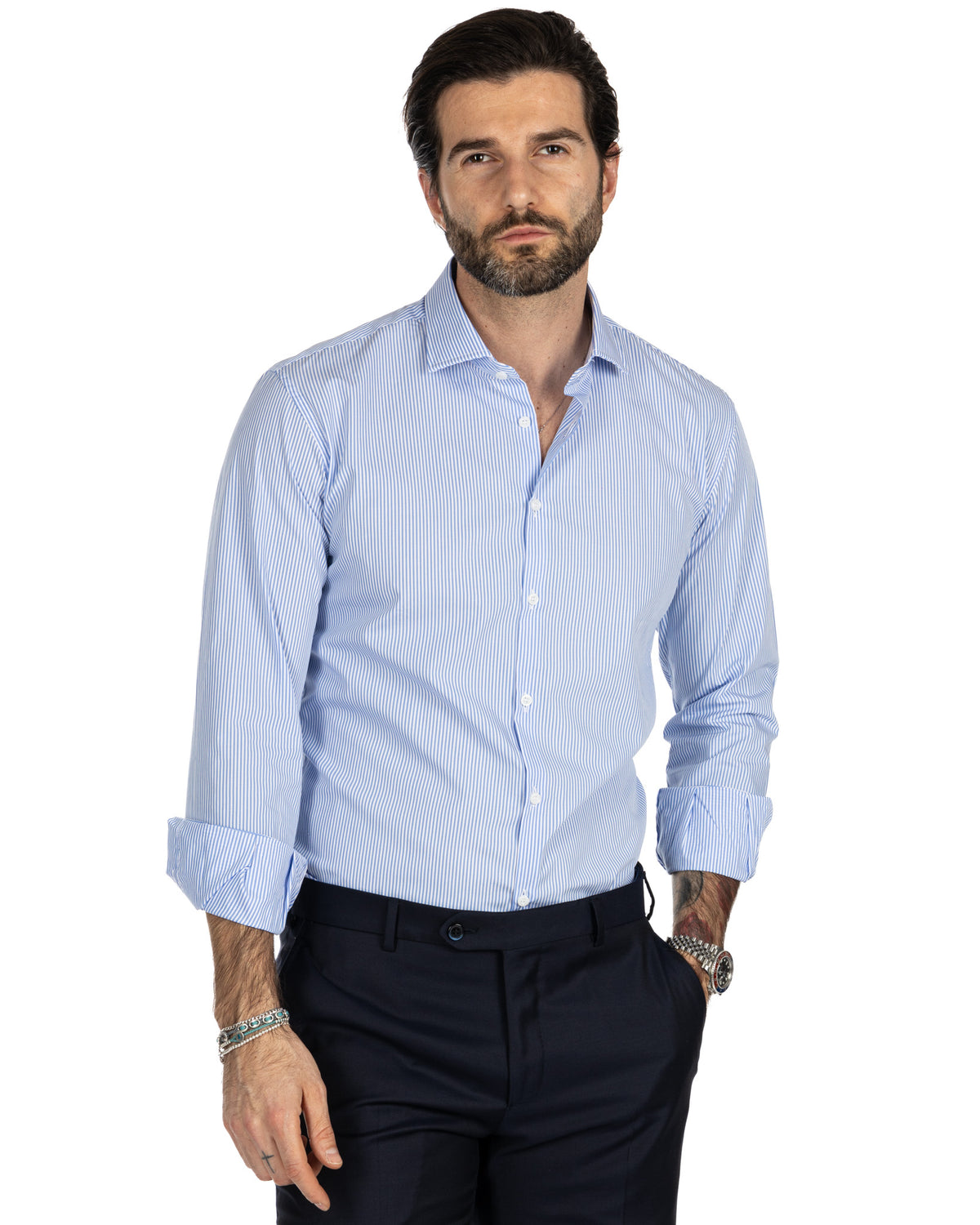 Men's light blue striped cotton dress shirt with spread collar, button front, and rolled sleeves.