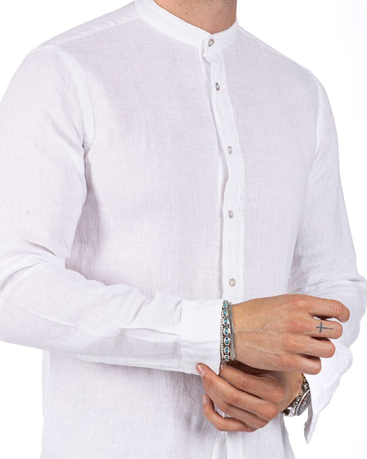 White linen band collar shirt with long sleeves, button front, and relaxed fit. Lightweight breathable fabric.