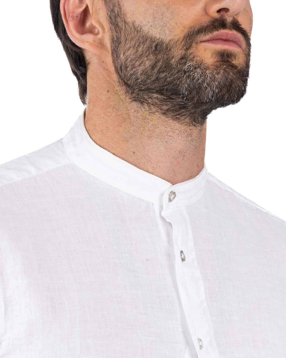 White linen men's banded collar shirt with button placket, close-up neck detail.