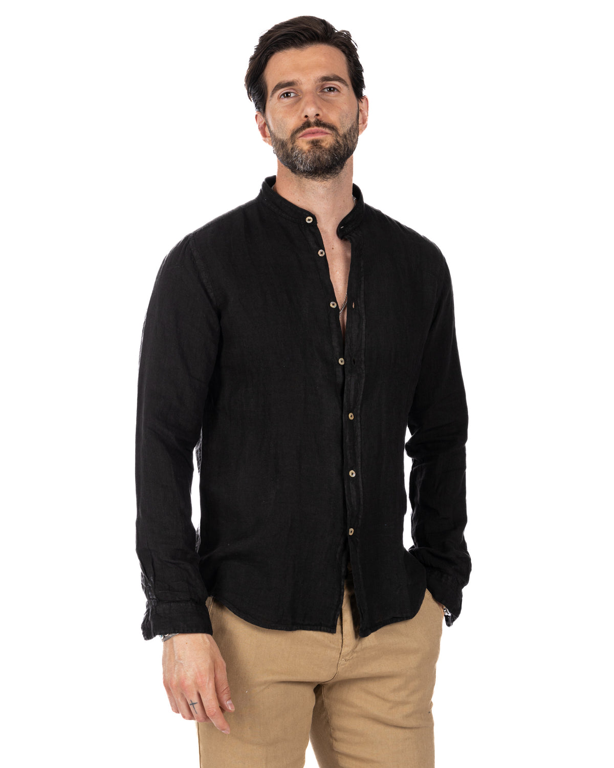 Men's black linen long-sleeve shirt with mandarin collar and button front, paired with tan chinos.