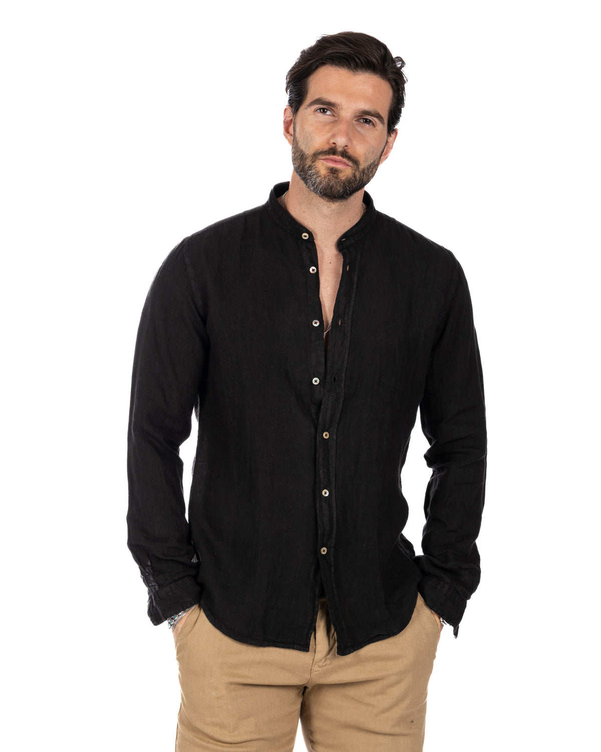 Black linen long-sleeve button-up shirt with mandarin collar, paired with tan chinos. Casual men's fashion.