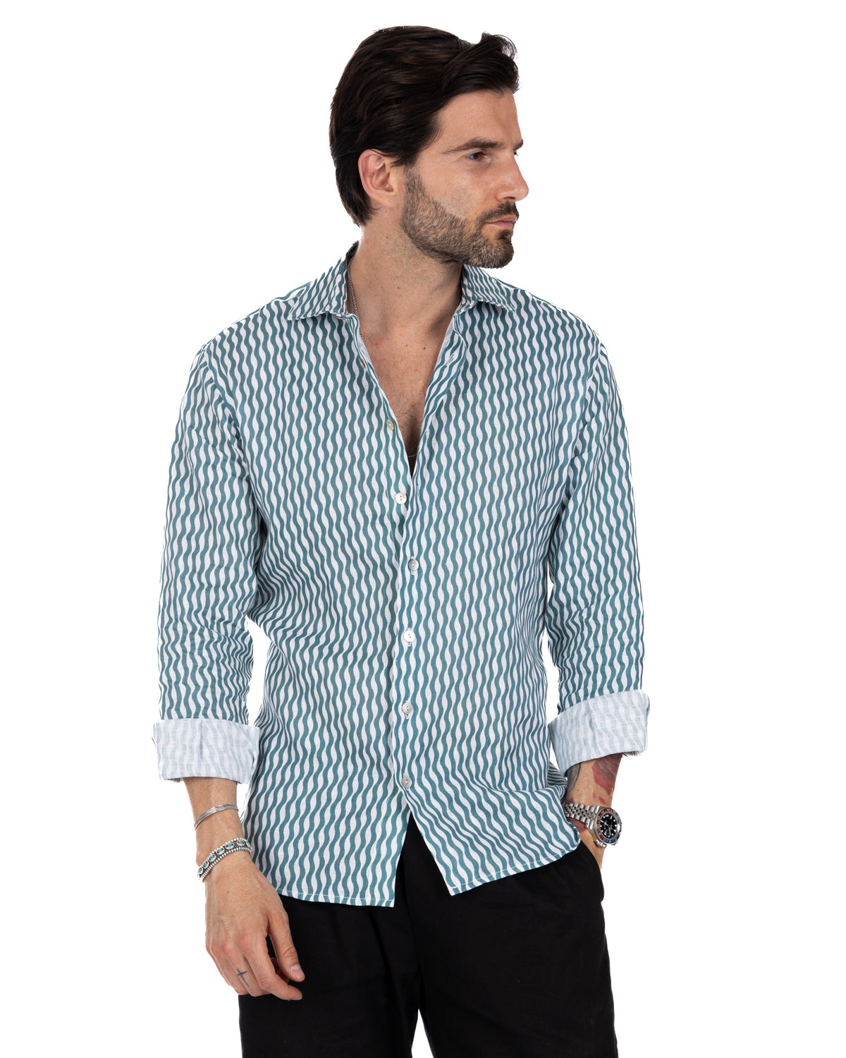 Men's slim-fit teal and white wavy striped linen button-down shirt with rolled cuffs and spread collar.