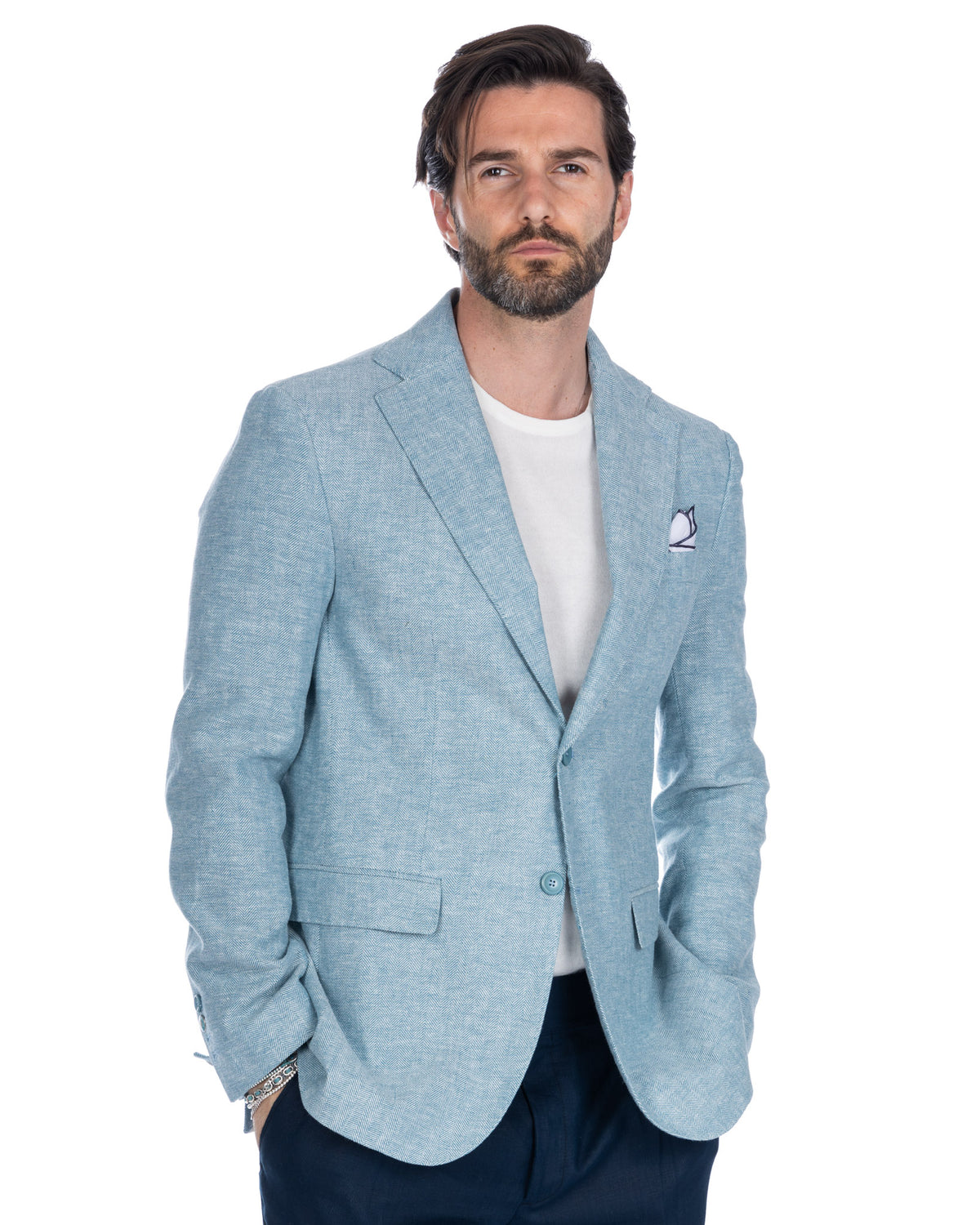 Light blue herringbone wool blazer with notched lapels, single button closure, and pocket square. Men's smart casual jacket.