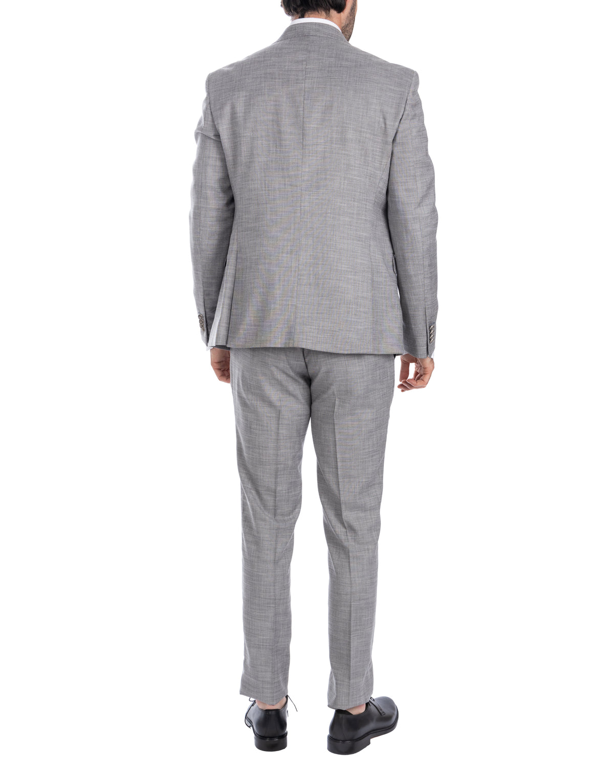 Light gray slim fit suit, back view. Wool blend fabric, tailored jacket and trousers with black dress shoes.