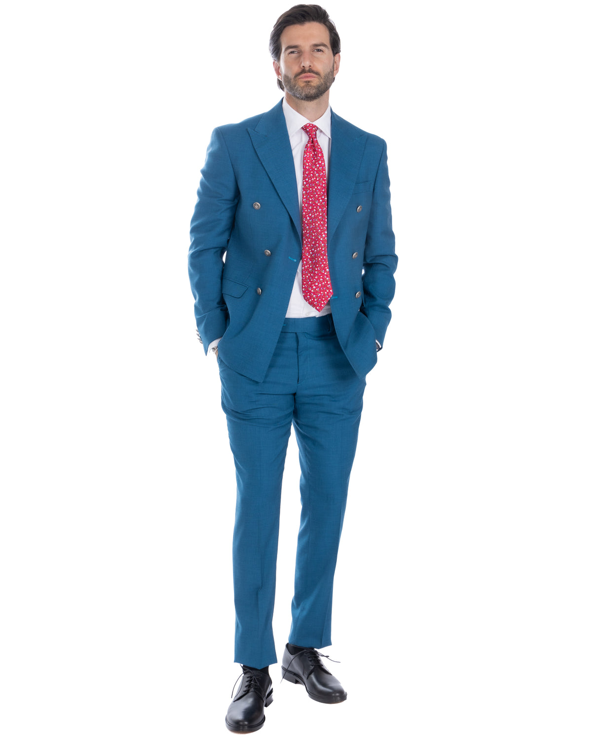 Teal blue double-breasted wool suit with red patterned tie, white dress shirt, and black leather oxford shoes.