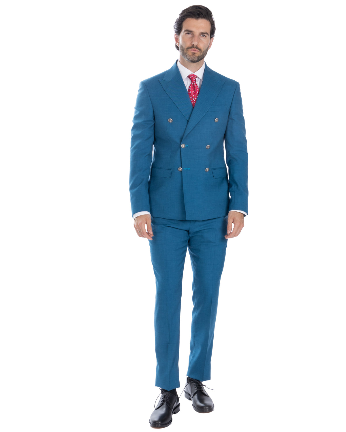 Teal blue double-breasted wool suit with red patterned tie, white dress shirt, and black leather oxford shoes.