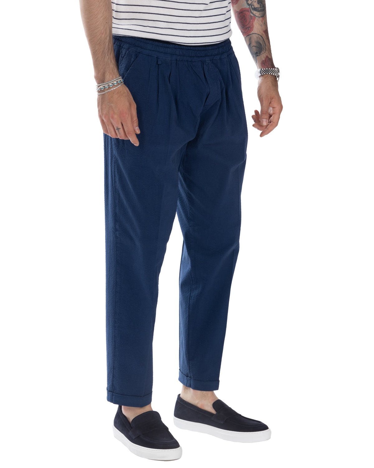 Navy blue relaxed fit seersucker pants with elastic waist, cuffed ankles. Men's casual summer trousers in textured cotton.