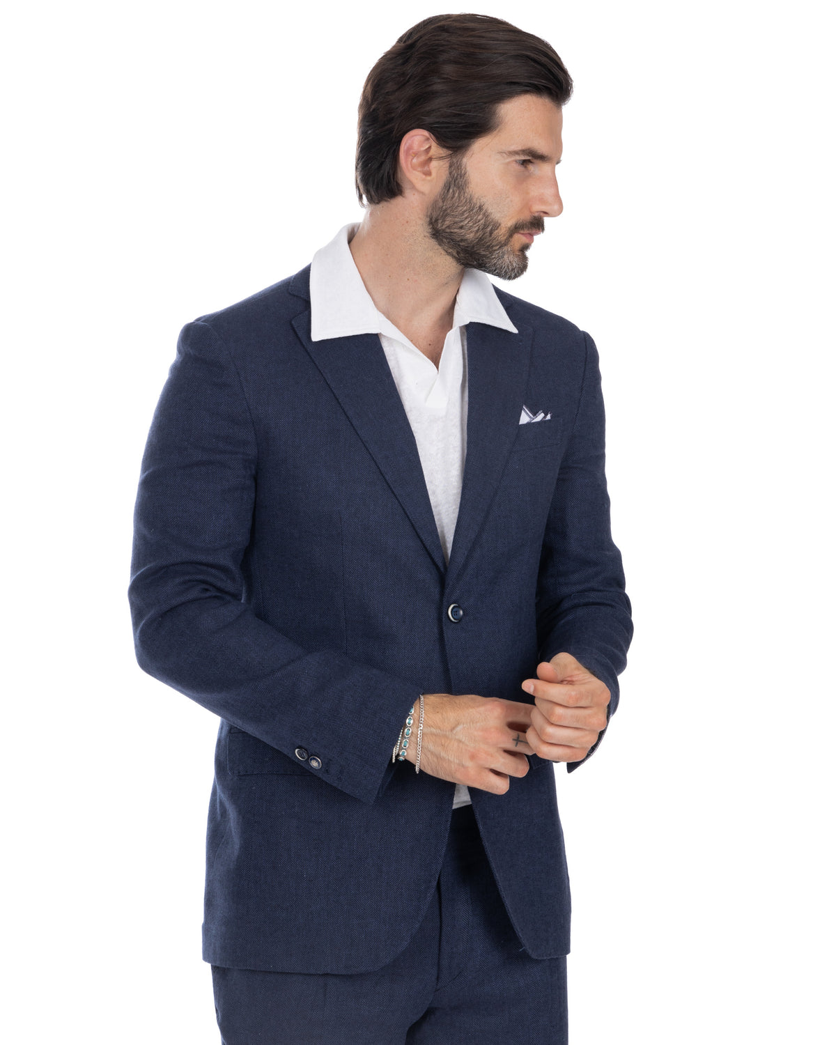 Navy blue herringbone wool suit jacket with white pocket square, paired with crisp white dress shirt.