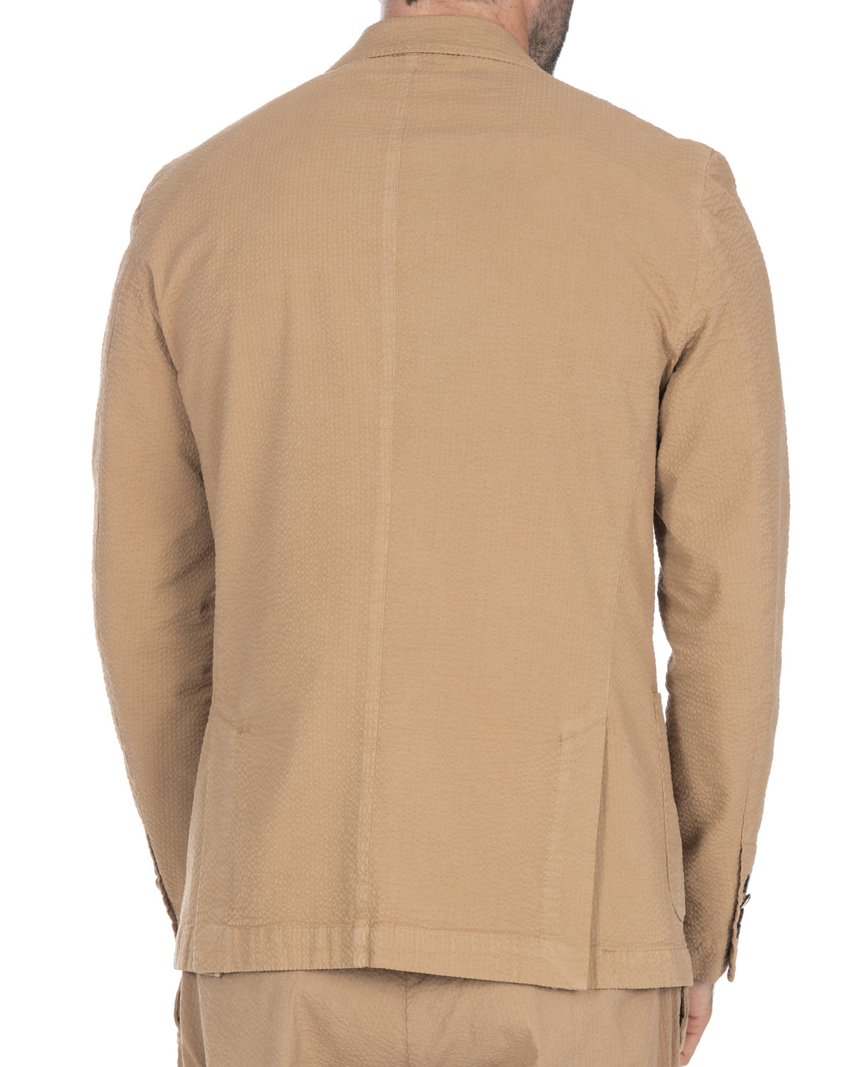 Beige seersucker cotton blazer, back view. Textured fabric, single vent, tailored fit.