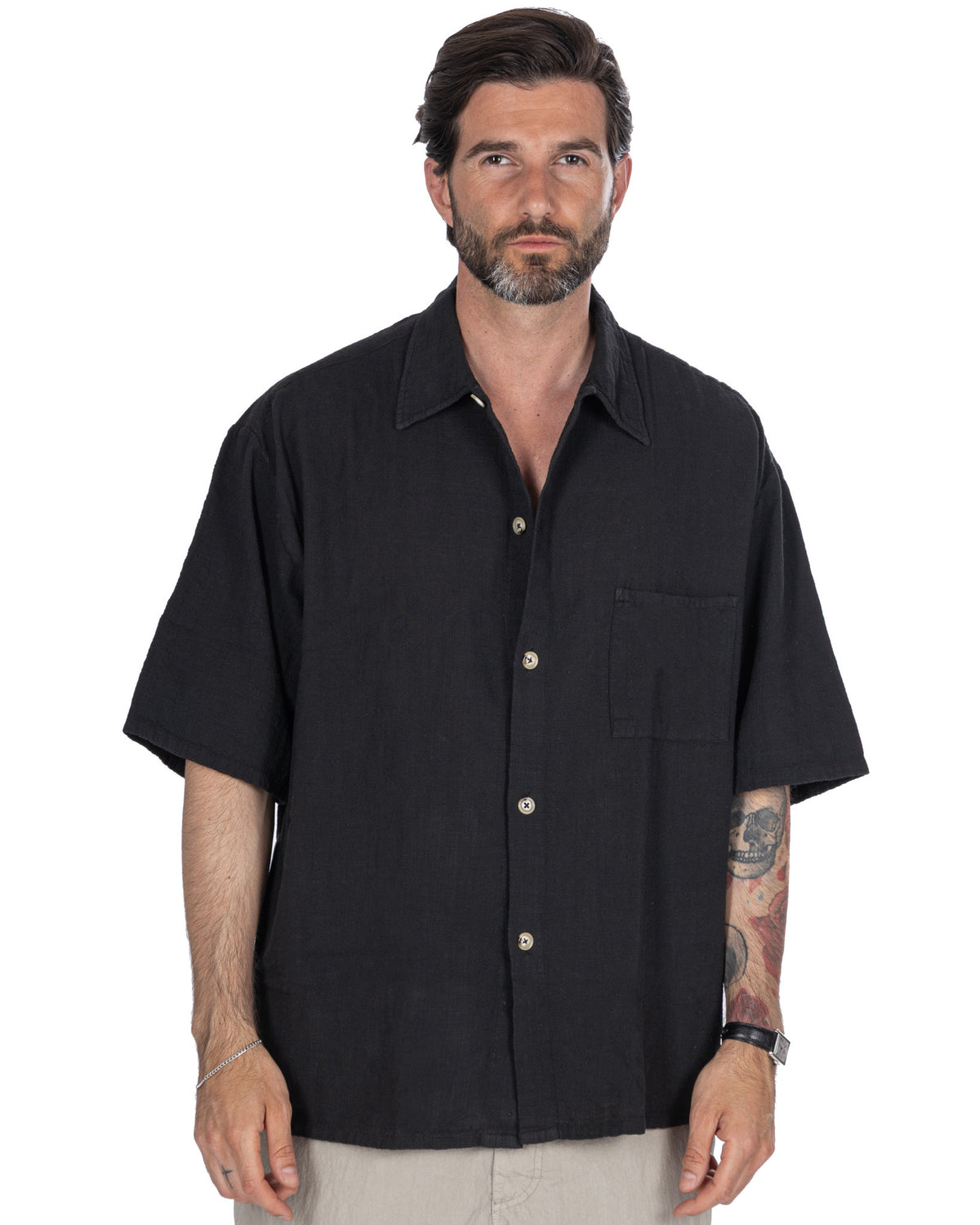 Black short sleeve linen button-up shirt with camp collar, chest pocket, and relaxed fit for men.