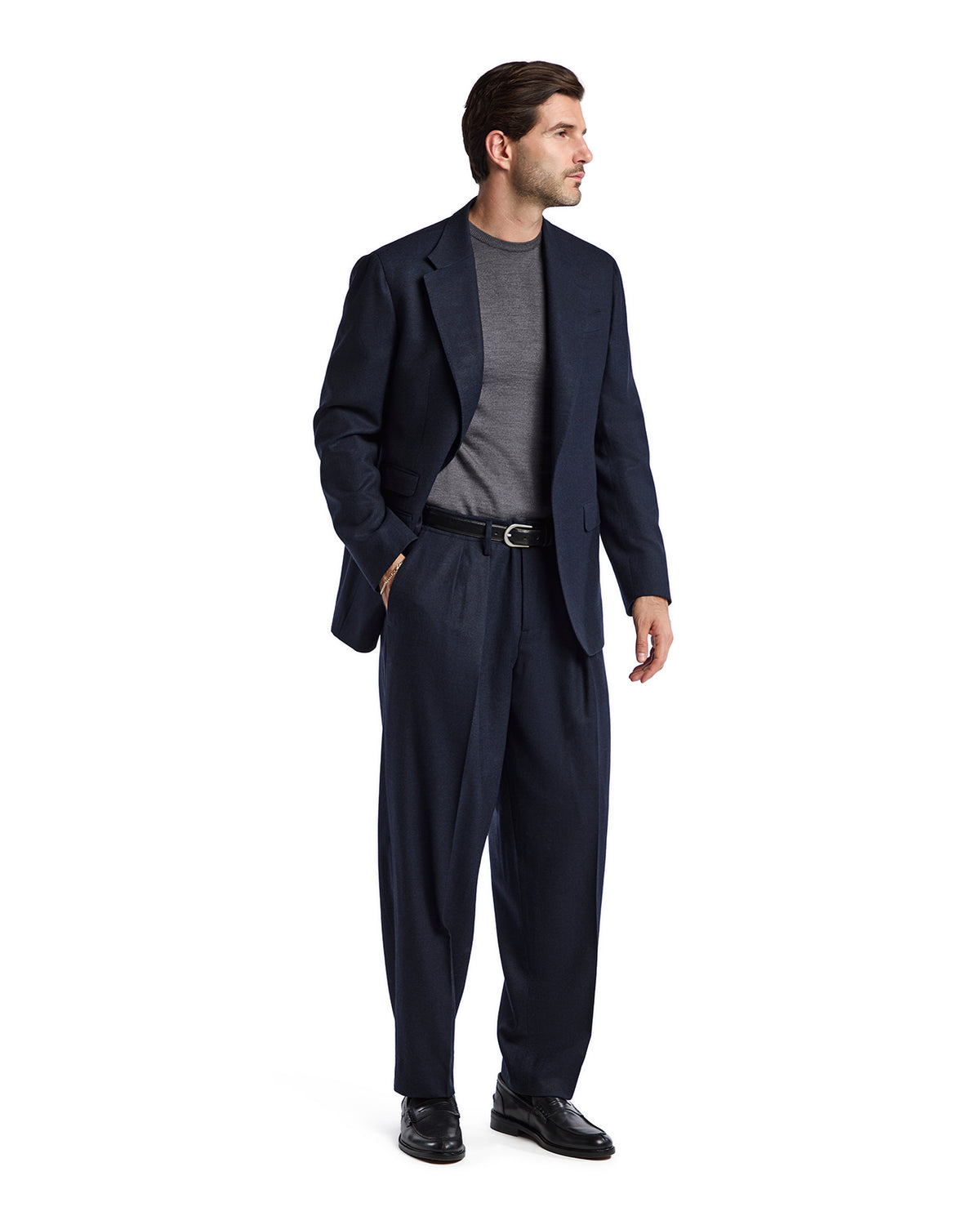 Navy blue wool suit with a gray crew neck shirt, featuring a relaxed fit and belt, ideal for formal occasions.