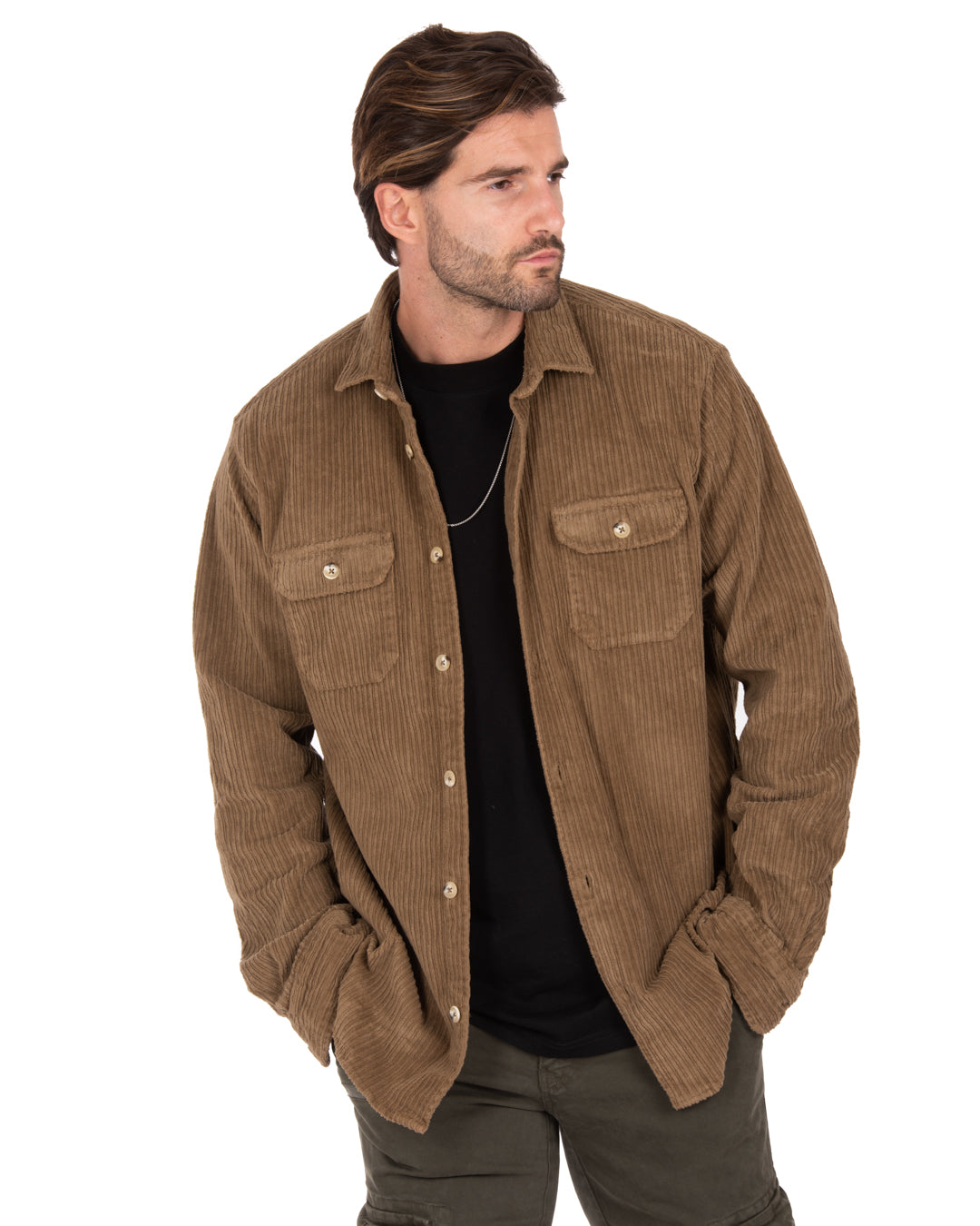 Brown corduroy shirt with two front pockets, styled for a relaxed, casual look. Perfect for layering or wearing alone.