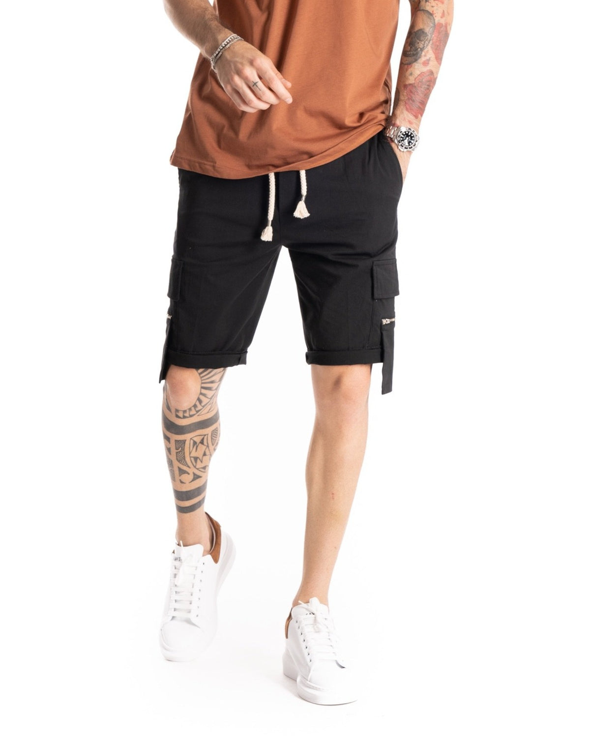 Black cargo shorts with drawstring waist, flap pockets and zip details, shown on a model