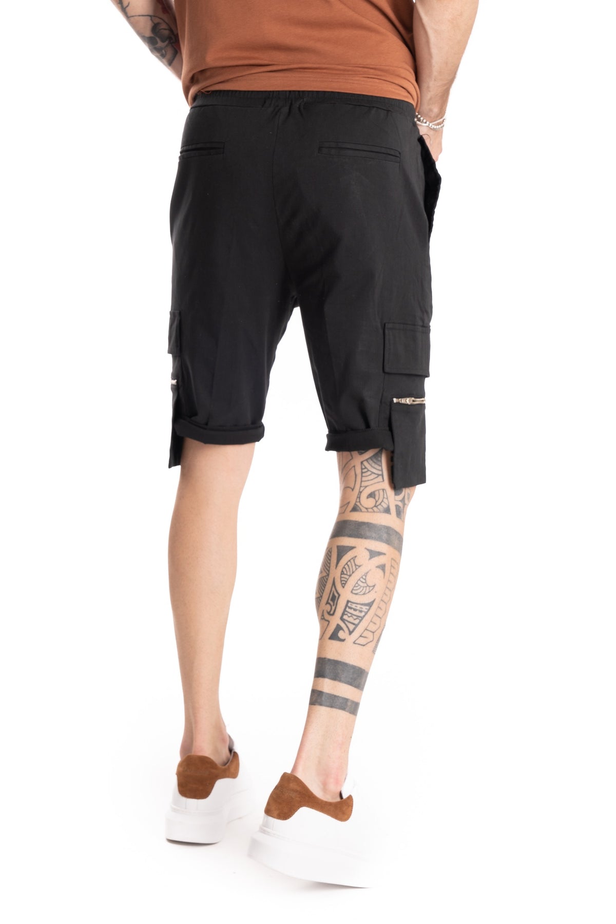 Black cargo shorts with flap pockets and zip details, shown from the back on a model