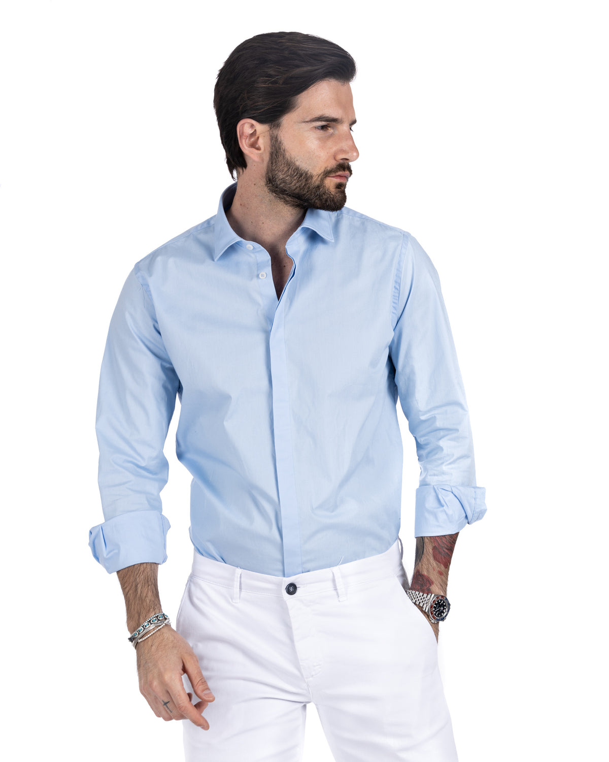 Men's light blue cotton shirt with hidden button placket and rolled cuffs, side profile view
