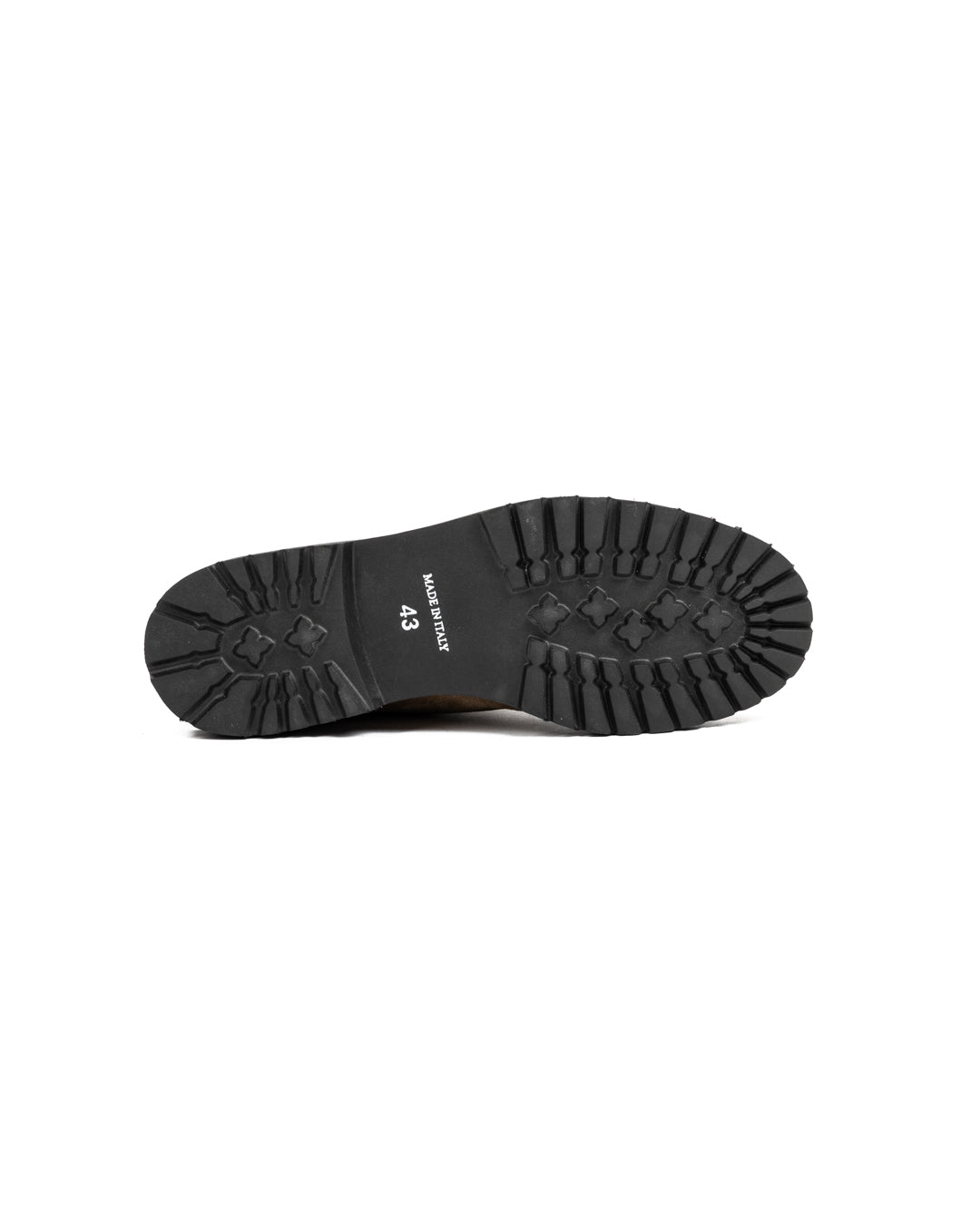 Black rubber lug sole of Italian-made size 43 boot, featuring deep tread pattern and embossed branding details.