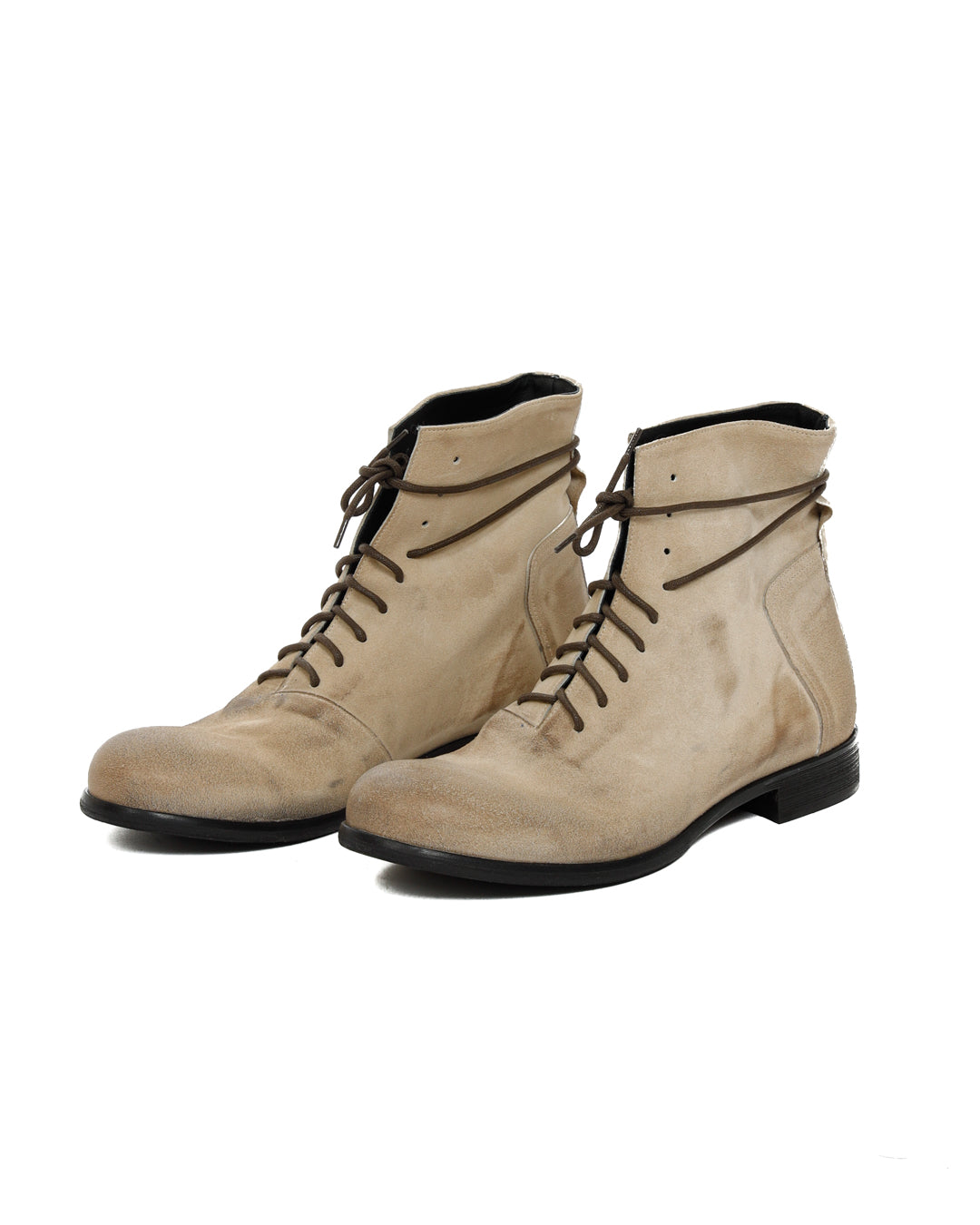 Pair of beige suede lace-up ankle boots with cord laces and black soles, shown at an angle