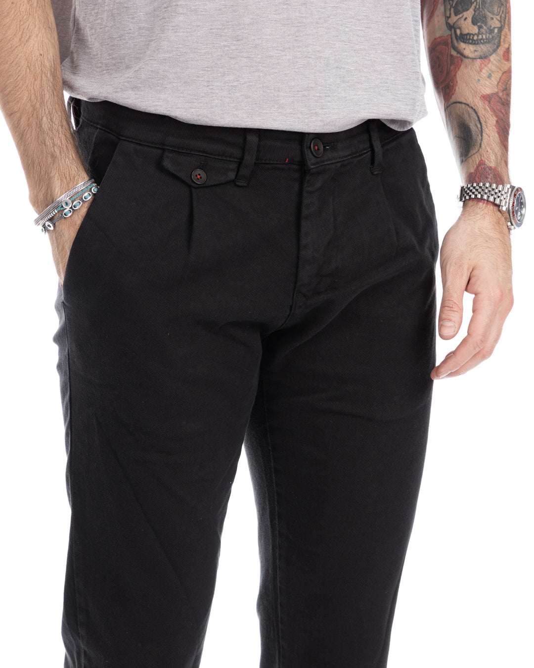 Men's black slim-fit chino pants with pleated front, button closure, and tapered leg.