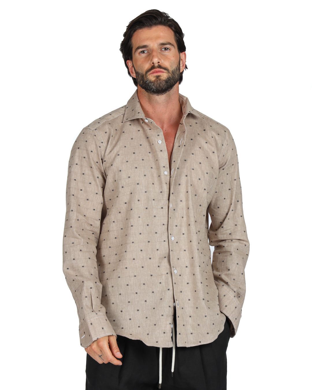 Men's beige linen shirt with brown dot pattern, shown on a model