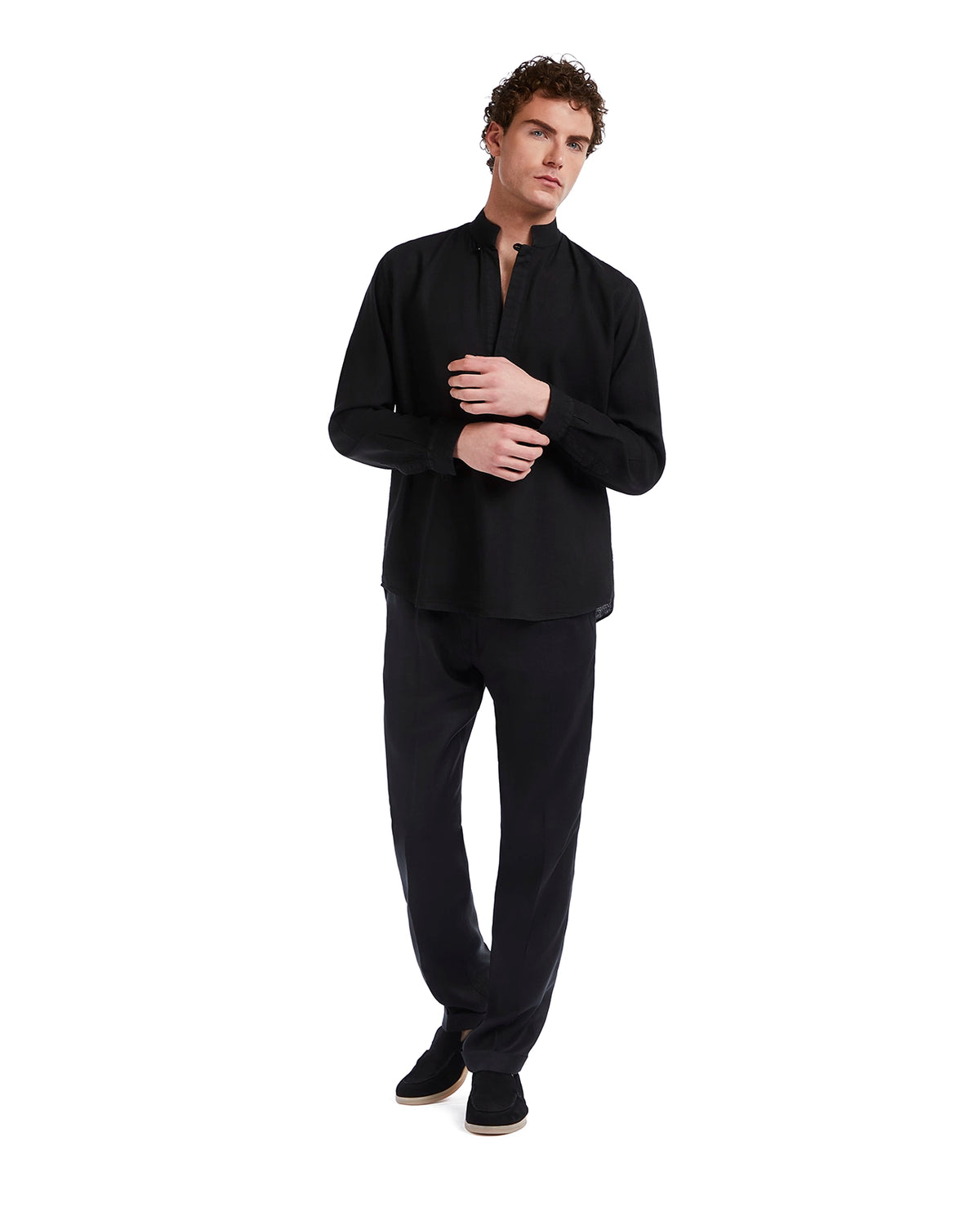 Black relaxed-fit long sleeve shirt in breathable fabric, paired with matching trousers for a sleek casual look.