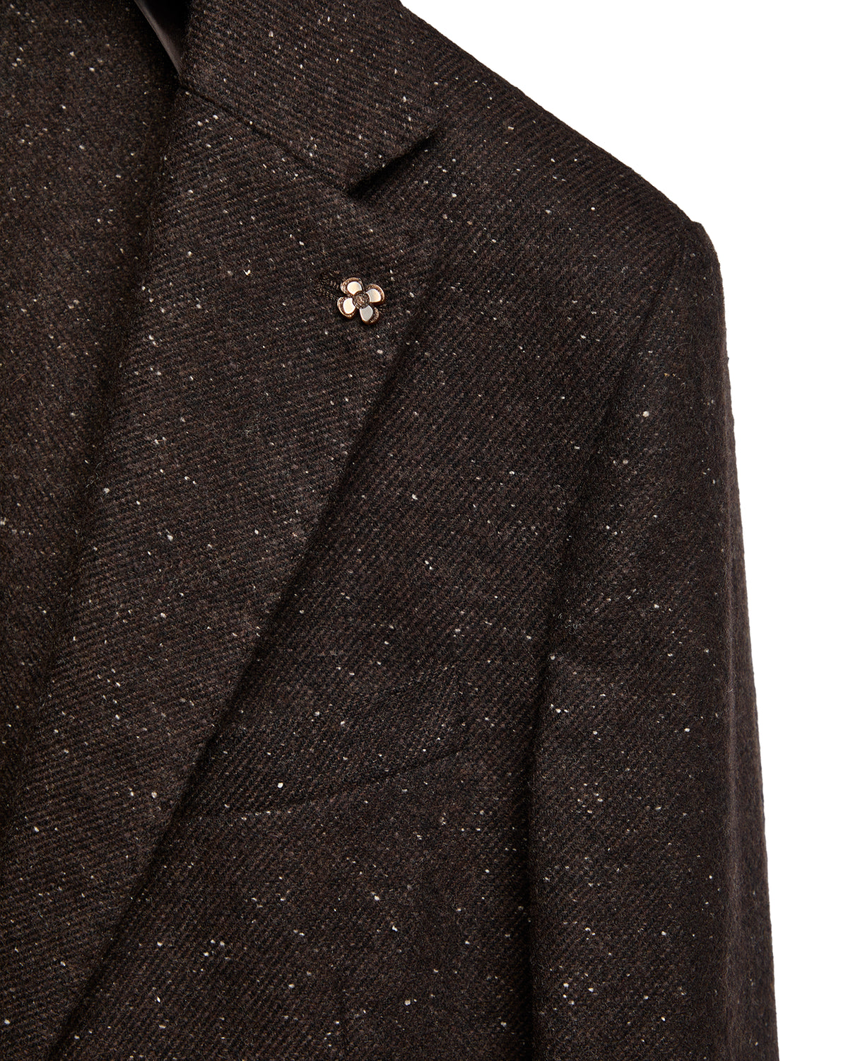 Brown tweed blazer featuring a subtle speckled pattern and flower lapel pin for a sophisticated, modern look.