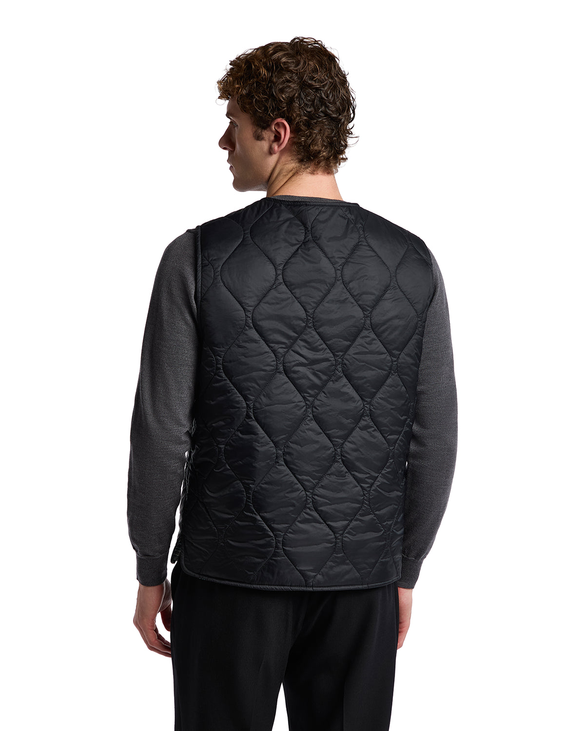Men's black quilted vest, lightweight nylon material, perfect for layering over a gray long-sleeve shirt.
