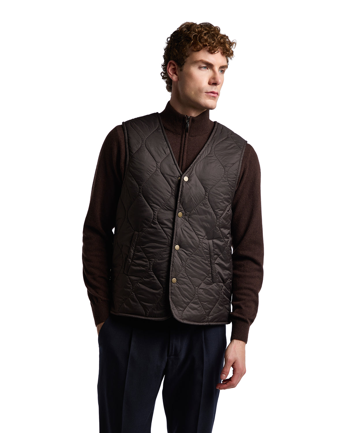 Men's chocolate brown quilted vest with zip mock neck, button closures, and lightweight insulation, styled for smart casual wear.