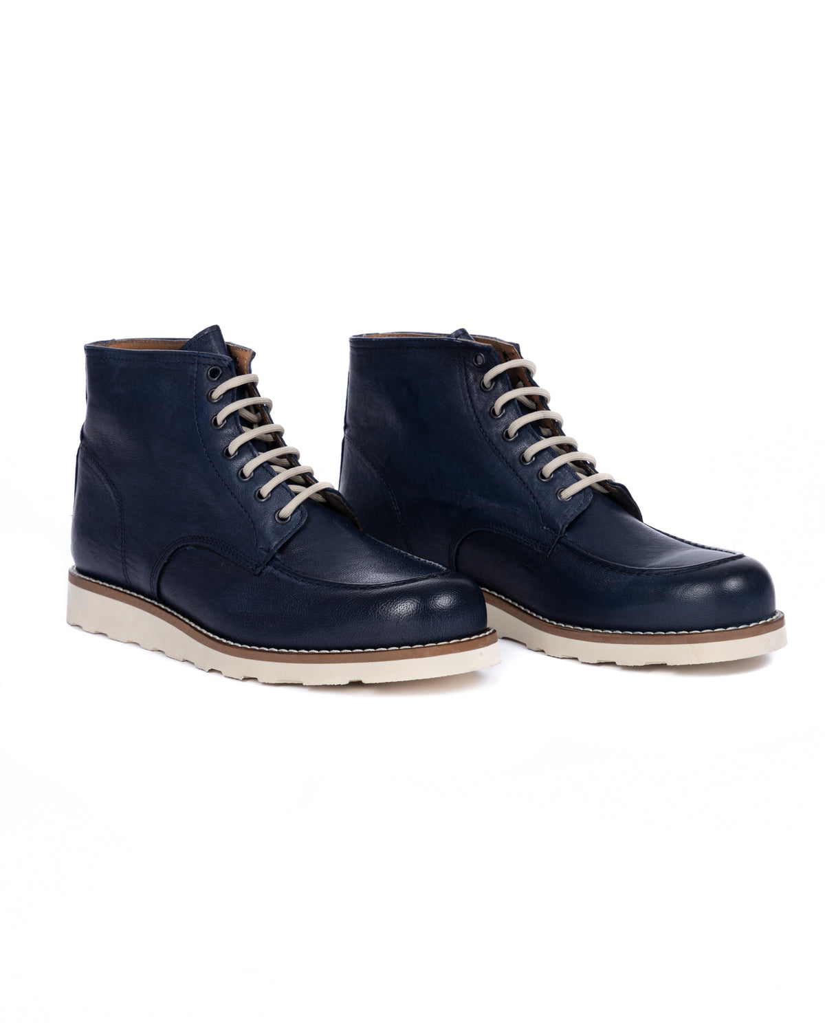 Navy blue leather lace-up ankle boots with cream laces and white rubber sole. Men's casual winter footwear.