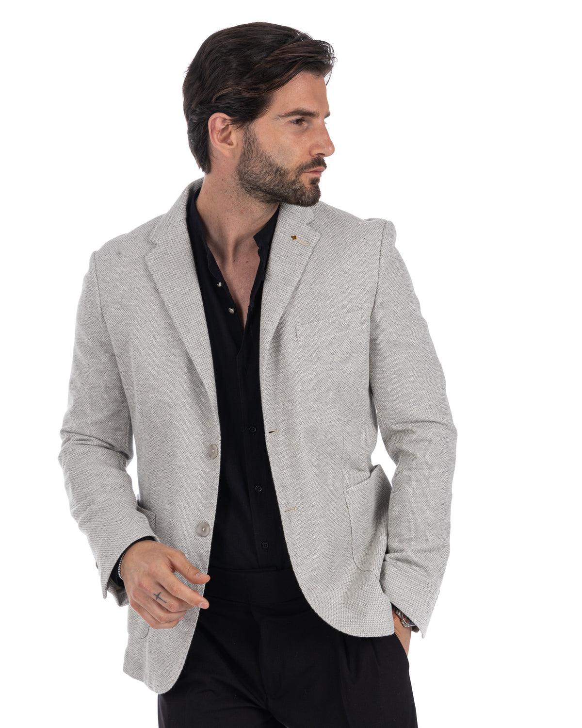 Light gray textured linen blazer for men, unlined summer jacket with notched lapels, paired with black shirt.