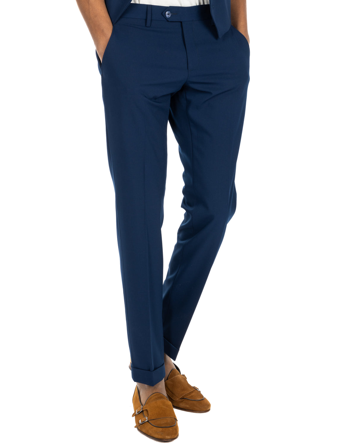 Navy blue slim-fit dress pants with cuffed hems, paired with tan suede double-strap loafers.