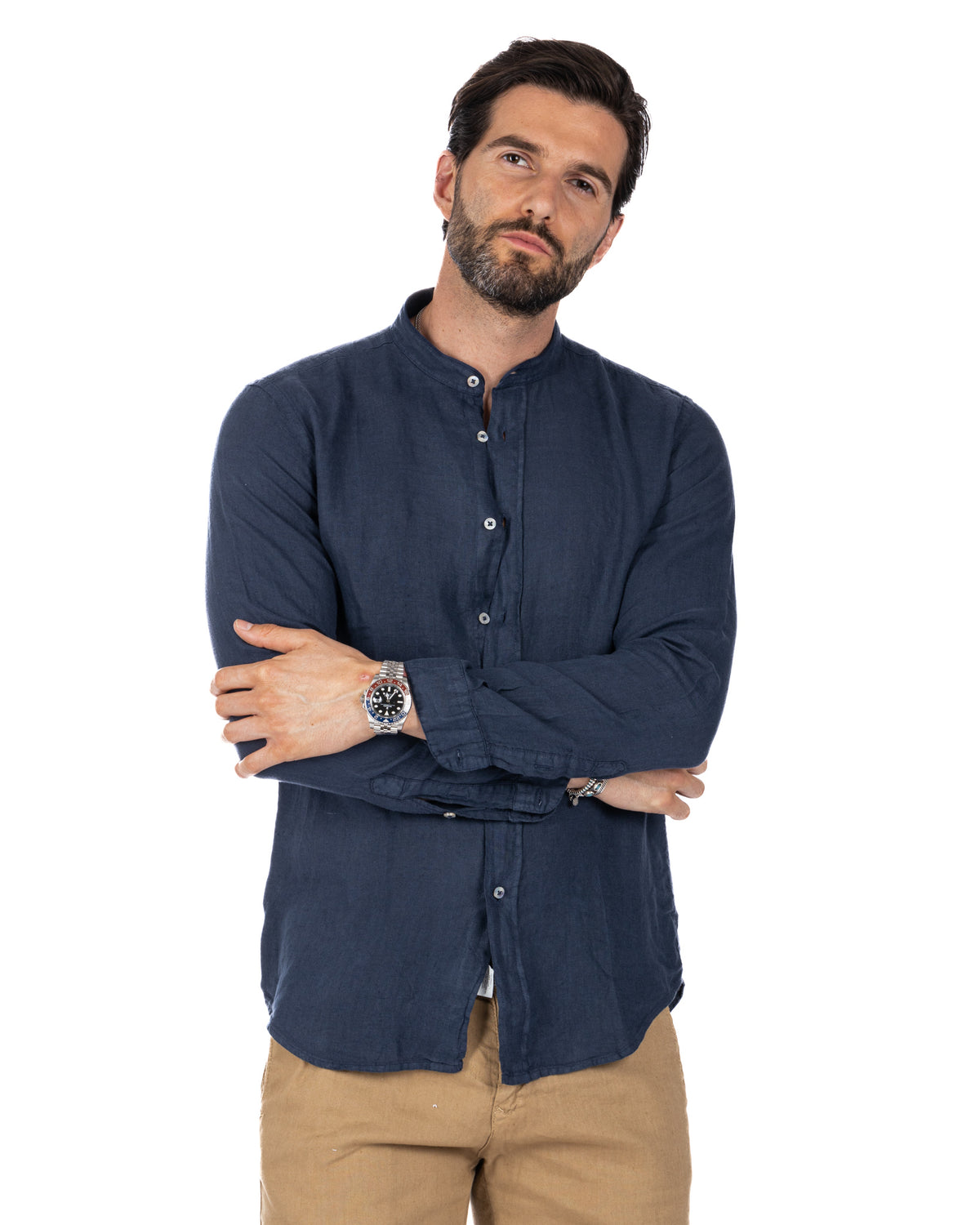 Navy blue linen band collar shirt with long sleeves, button front, paired with tan chinos.
