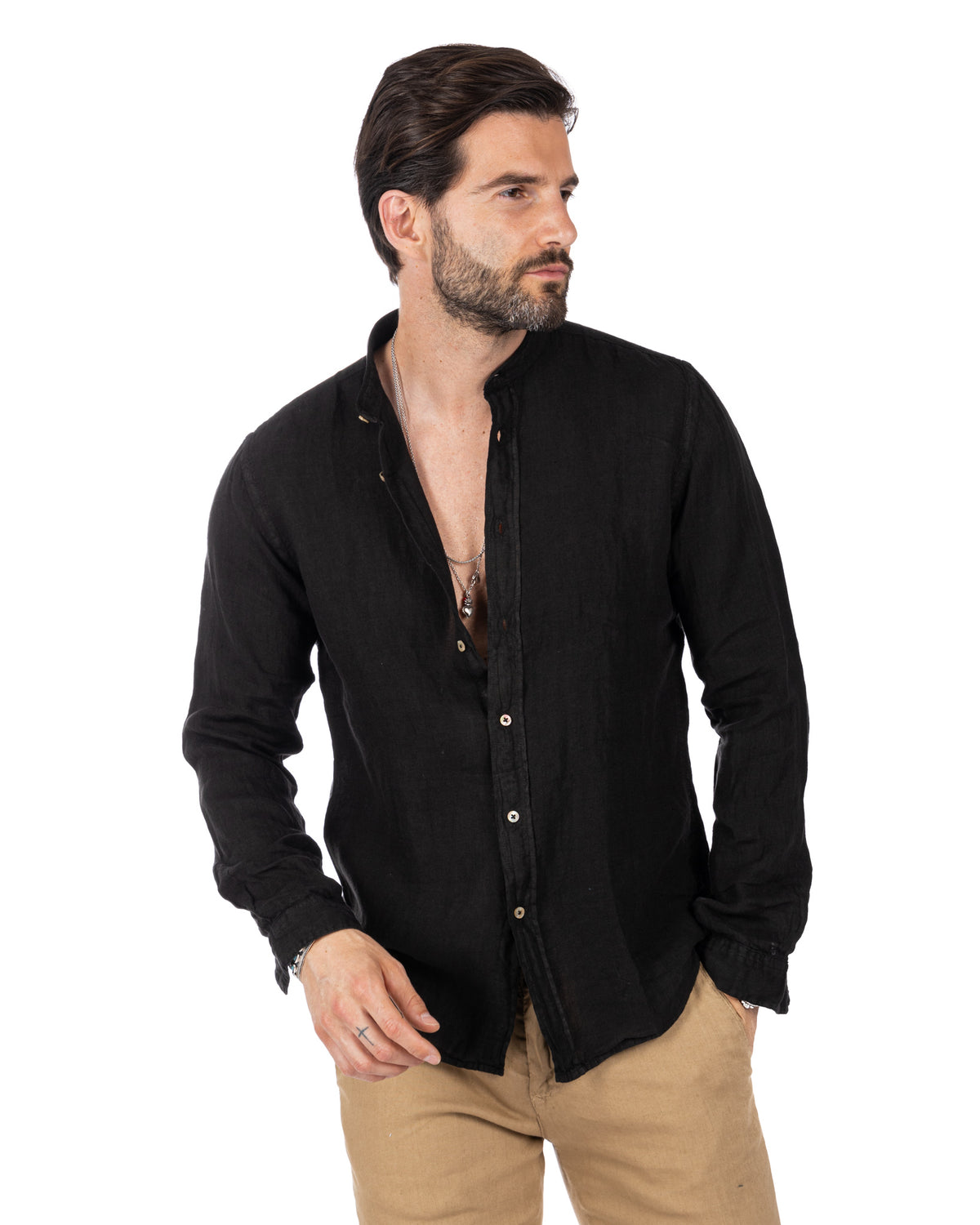 Men's black linen long-sleeve button-down shirt, relaxed fit, paired with tan chinos. Casual summer style.