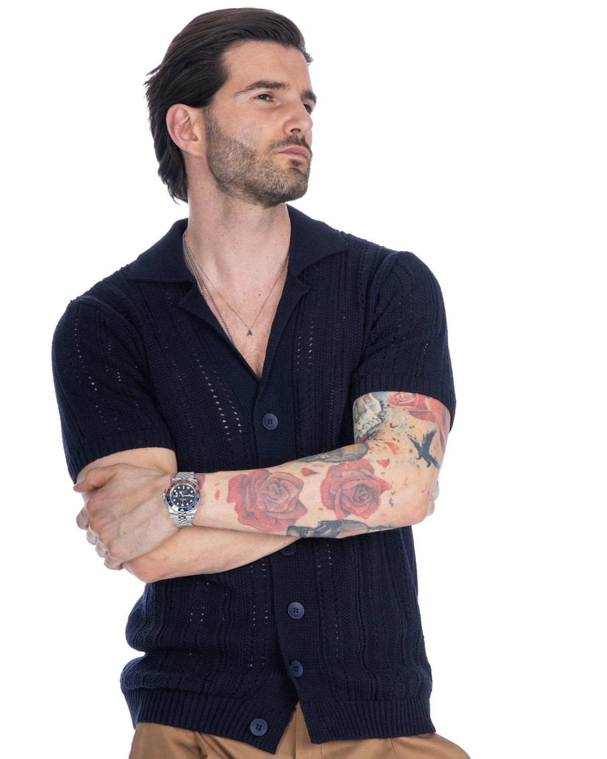 Navy blue short sleeve knit cardigan with pointelle details, button front, and ribbed trim.