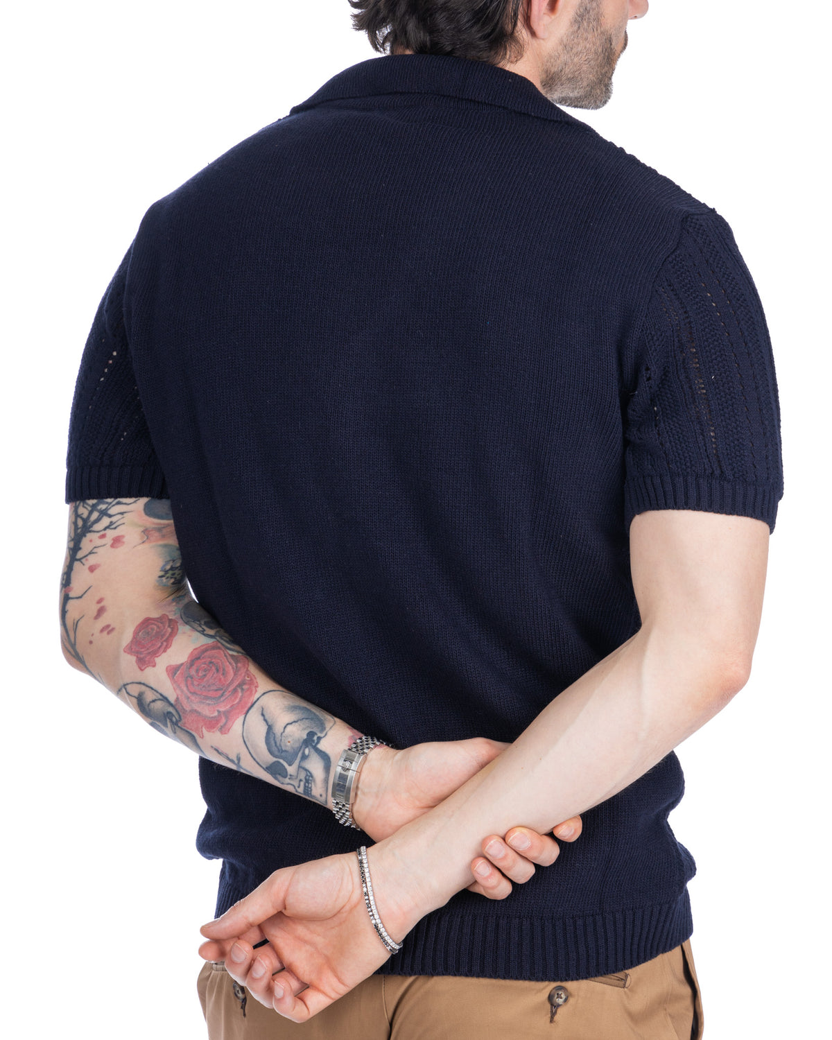 Navy blue short sleeve knit polo shirt for men, cotton blend, slim fit, ribbed collar and cuffs, back view.
