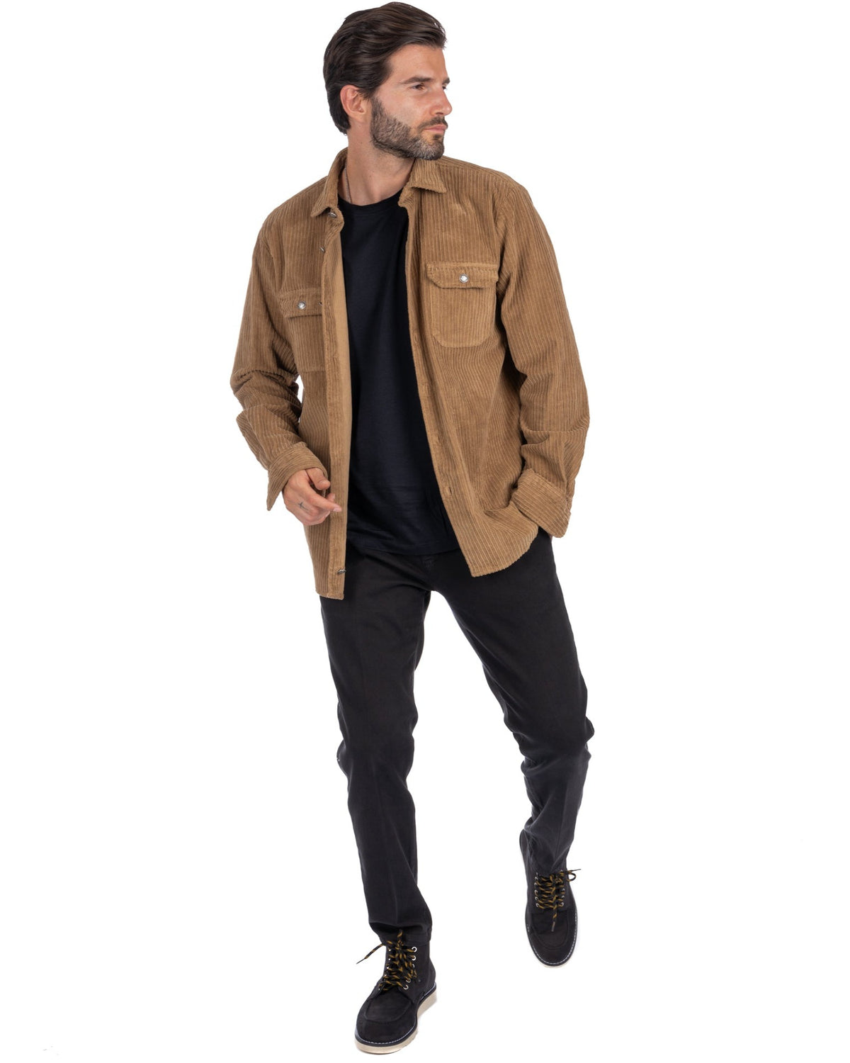 Men's tan corduroy shirt jacket with button pockets, styled over black tee and pants. Casual fall outerwear.