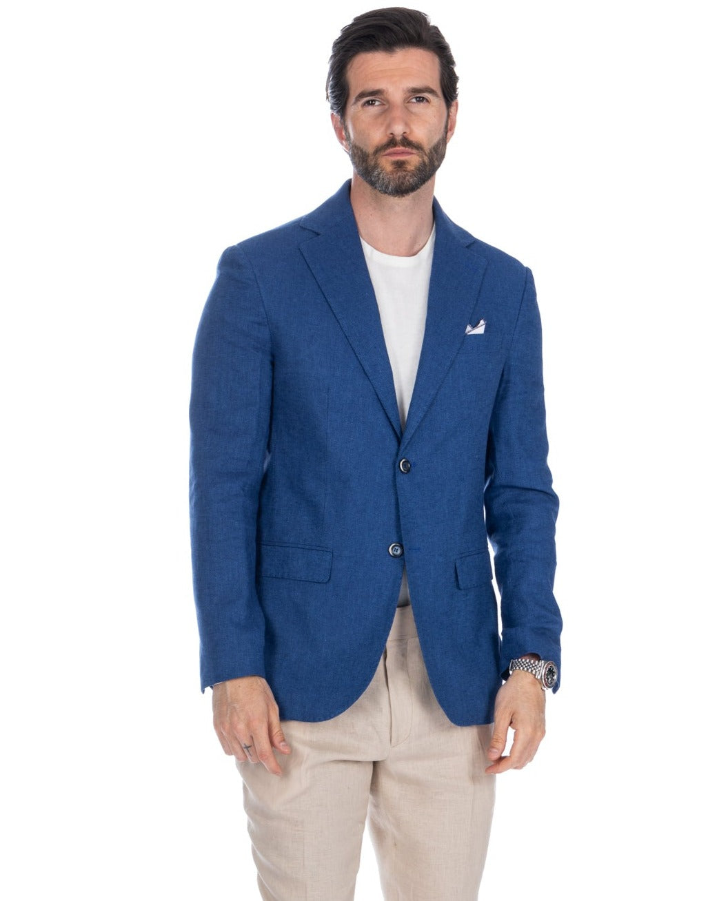 Royal blue linen blazer with notched lapels, two-button closure, and patch pockets. Paired with beige trousers.
