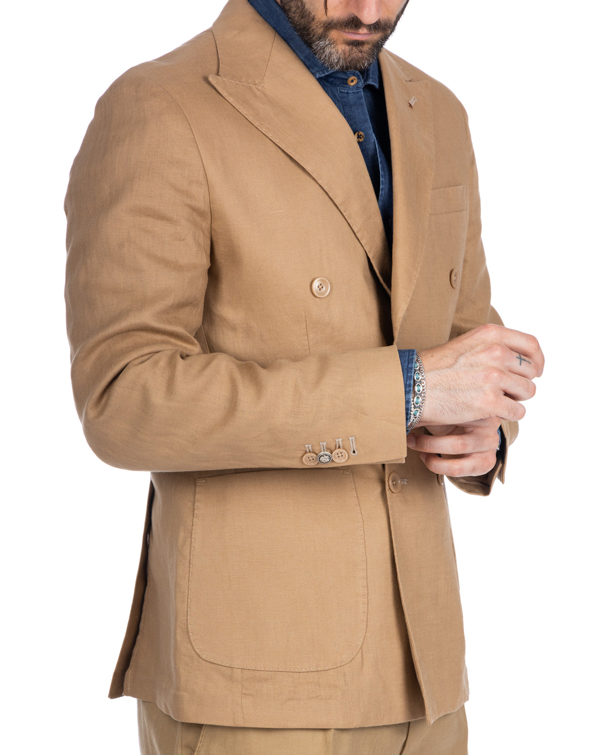 Tan linen double-breasted blazer with peak lapels, horn buttons, and patch pockets. Unlined summer suit jacket.