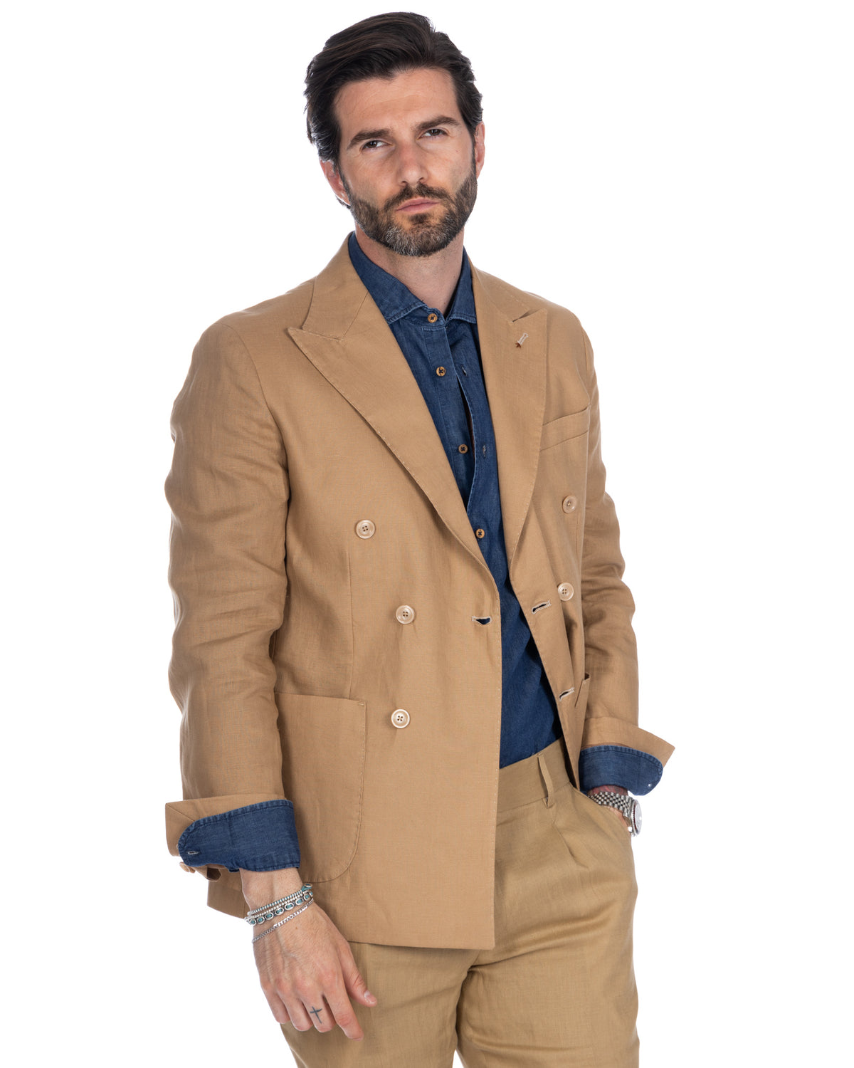 Tan linen double-breasted suit with blue denim shirt, tailored fit, peak lapels, and horn buttons.