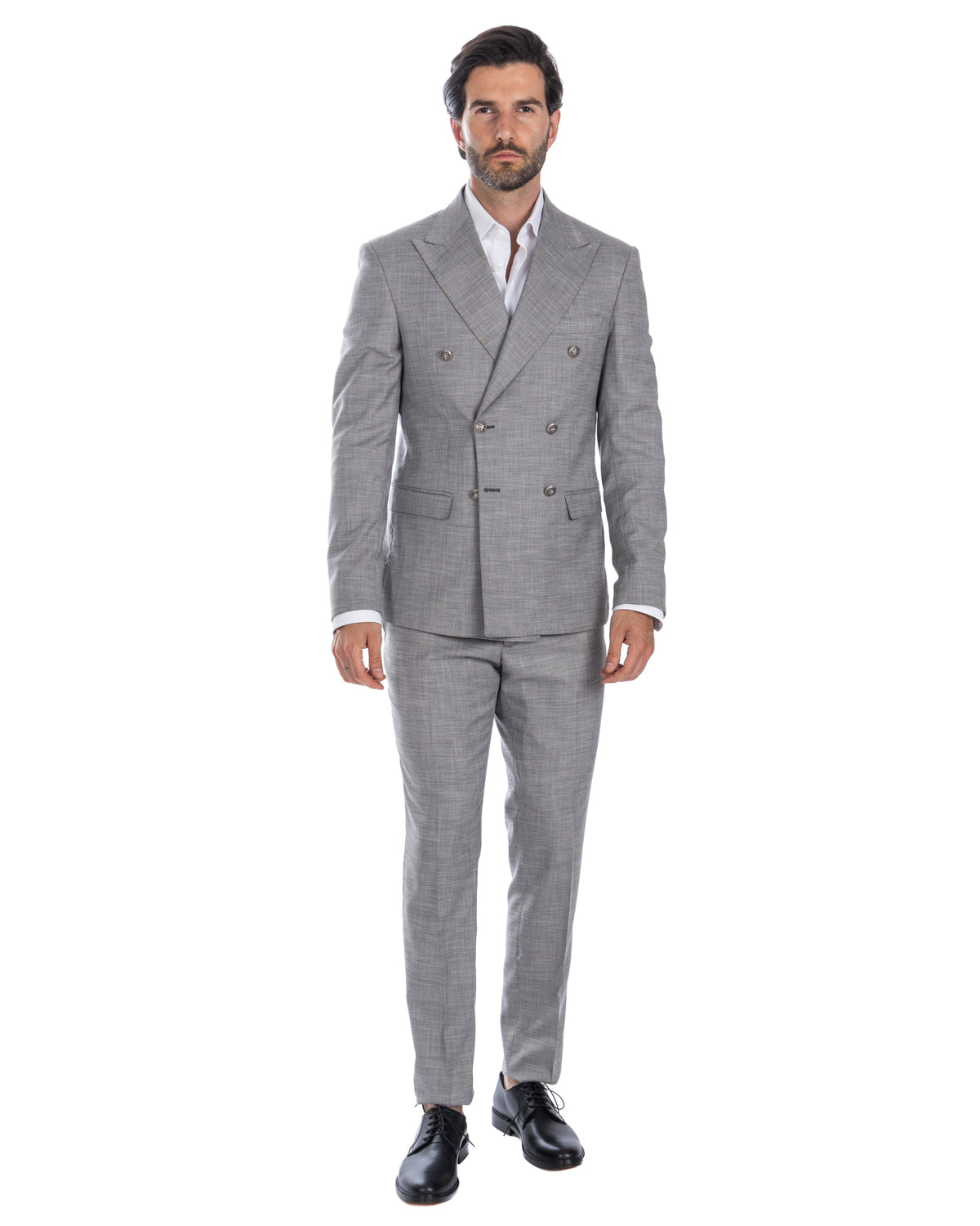 Men's light gray double-breasted wool suit with peak lapels, white dress shirt, and black leather oxford shoes.
