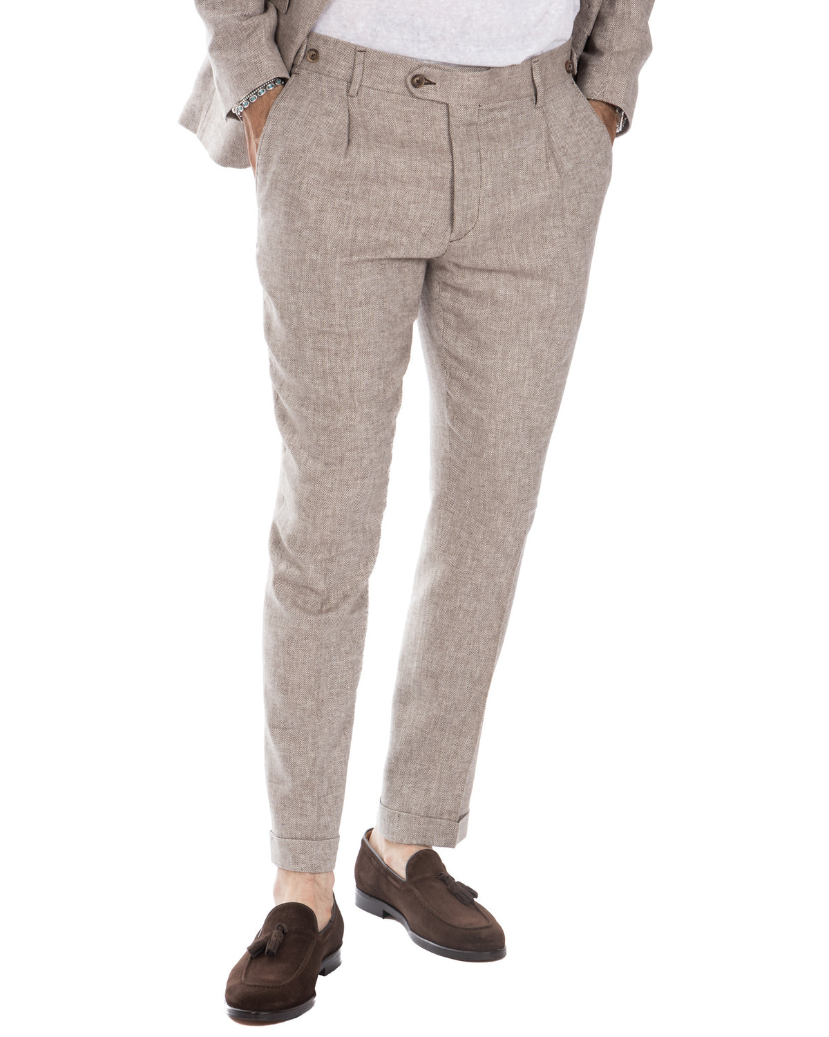 Beige herringbone wool dress pants with pleated front, tailored fit, and cuffed ankles. Classic men's formal trousers.