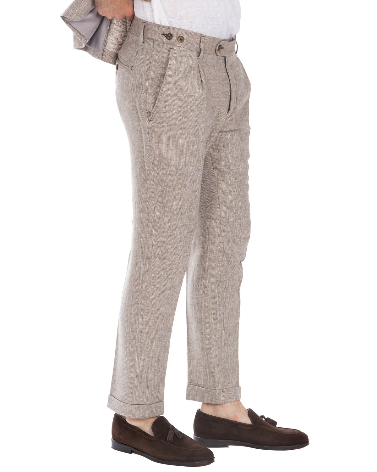 Beige herringbone wool dress pants with pleats, side adjusters, and cuffed hem. Men's tailored trousers.
