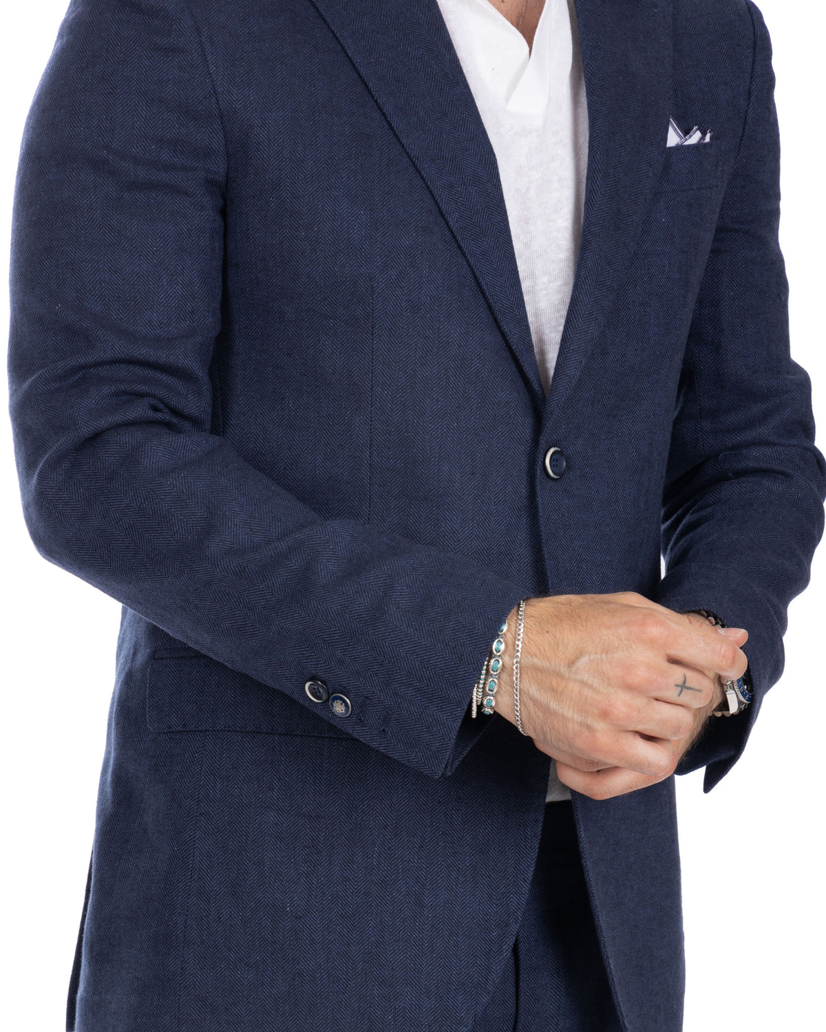 Navy blue herringbone wool blazer with notched lapels, single button closure, and pocket square. Men's tailored sport coat.