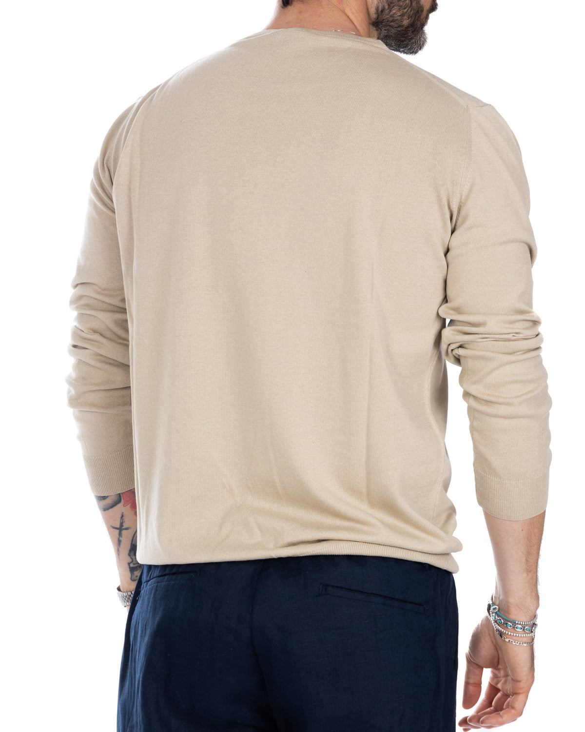 Beige cotton crewneck sweater, long sleeves with ribbed cuffs, relaxed fit, back view.