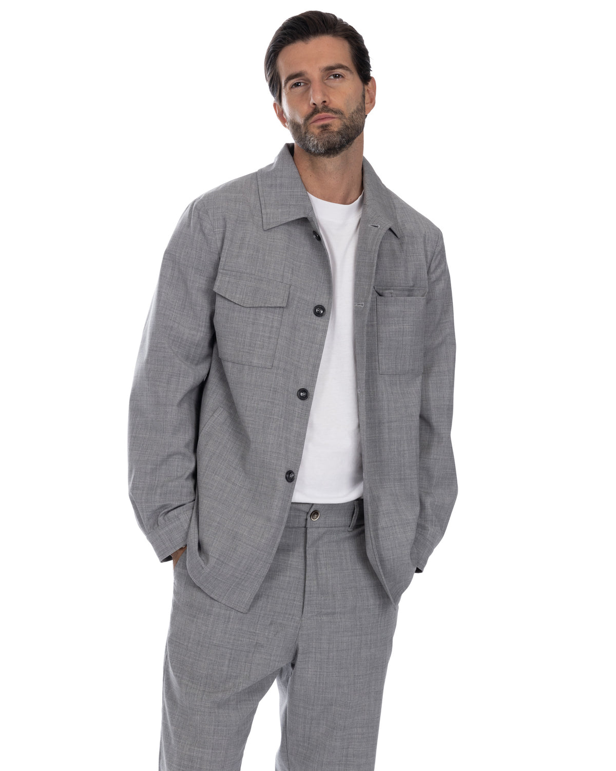 Men's grey wool blend overshirt jacket with button front, chest pockets, and matching trousers. Relaxed fit casual suit.