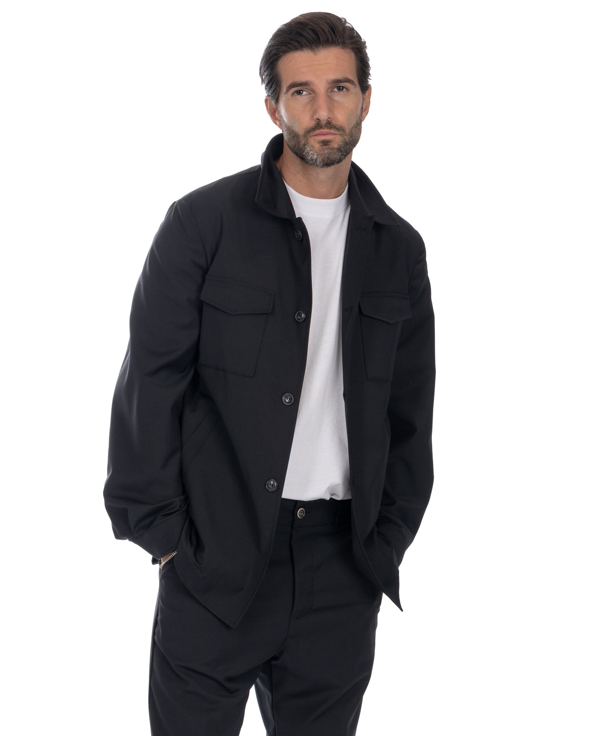 Black button-up shirt jacket with chest pockets, worn over white tee. Men's casual lightweight overshirt in solid black.