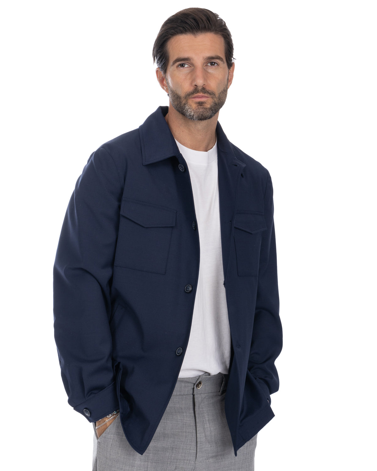 Navy blue wool overshirt jacket with button front, chest pockets, and relaxed fit. Men's smart-casual outerwear.